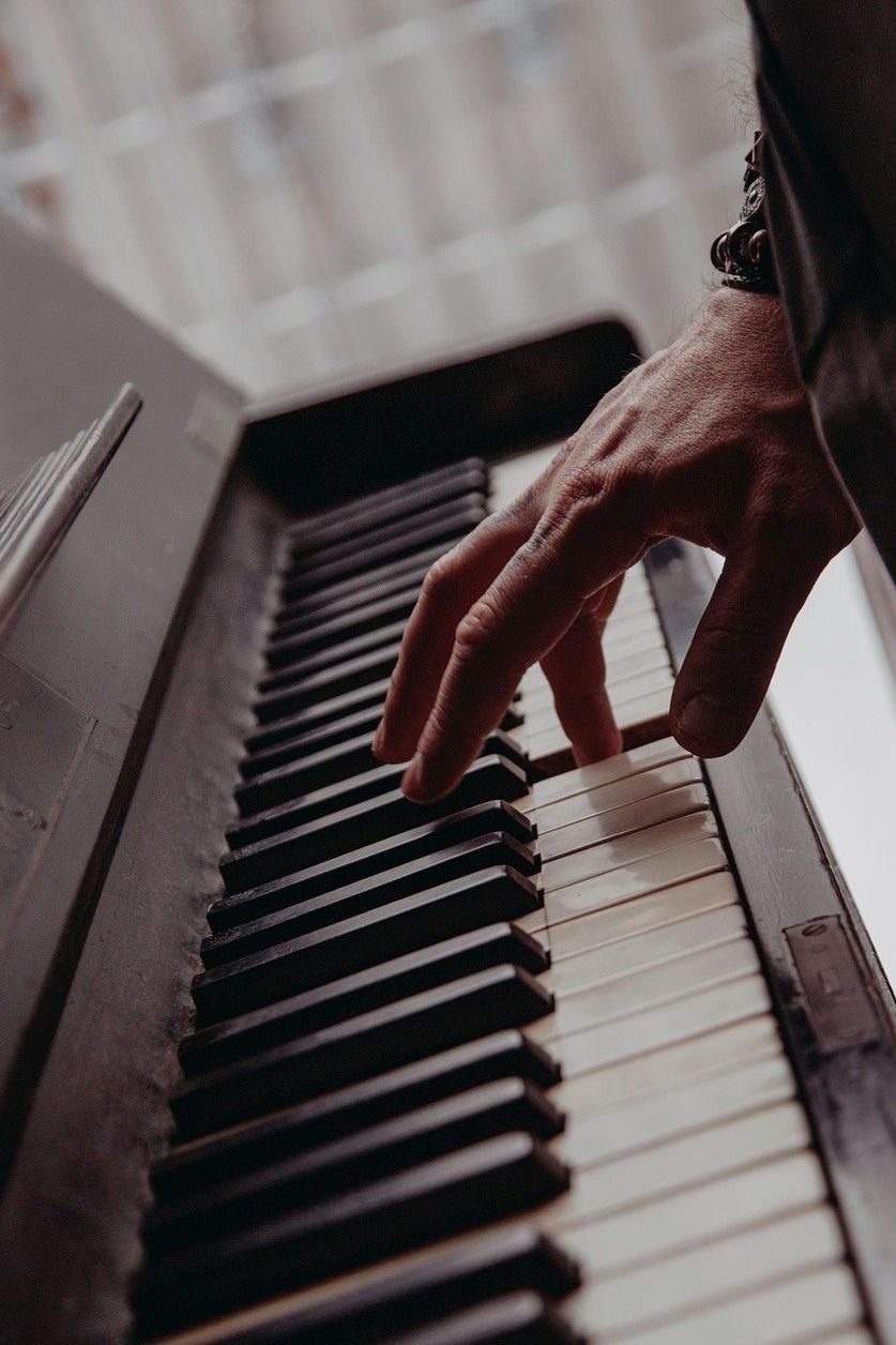 Hand playing piano keys